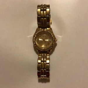 woman’s gold watch Guess